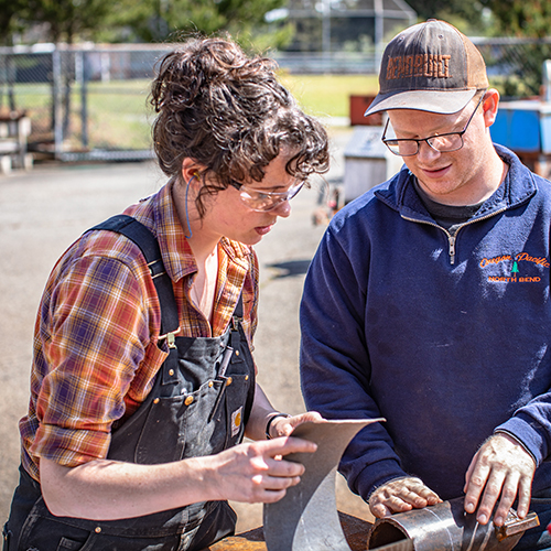 woman and man working on a welding project