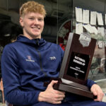 image of a young man holding a trophy