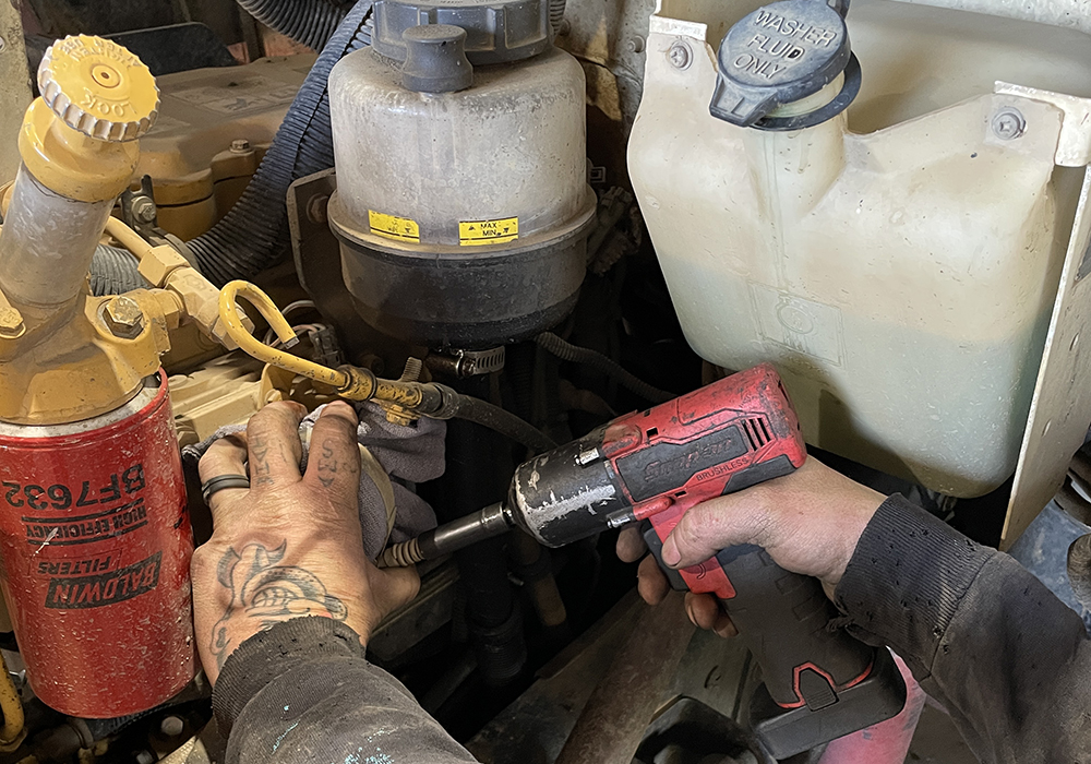 engine image for job info - web image of hand working on an engine with tools