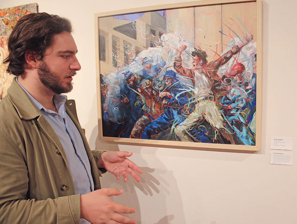 Image is of a man standing in front of a painting.