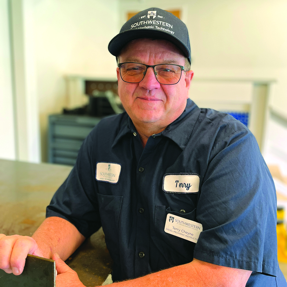 portrait of a man in a blue shirt and cap