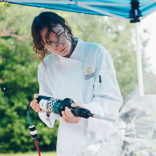 photo of an OCCI student sculpting ice