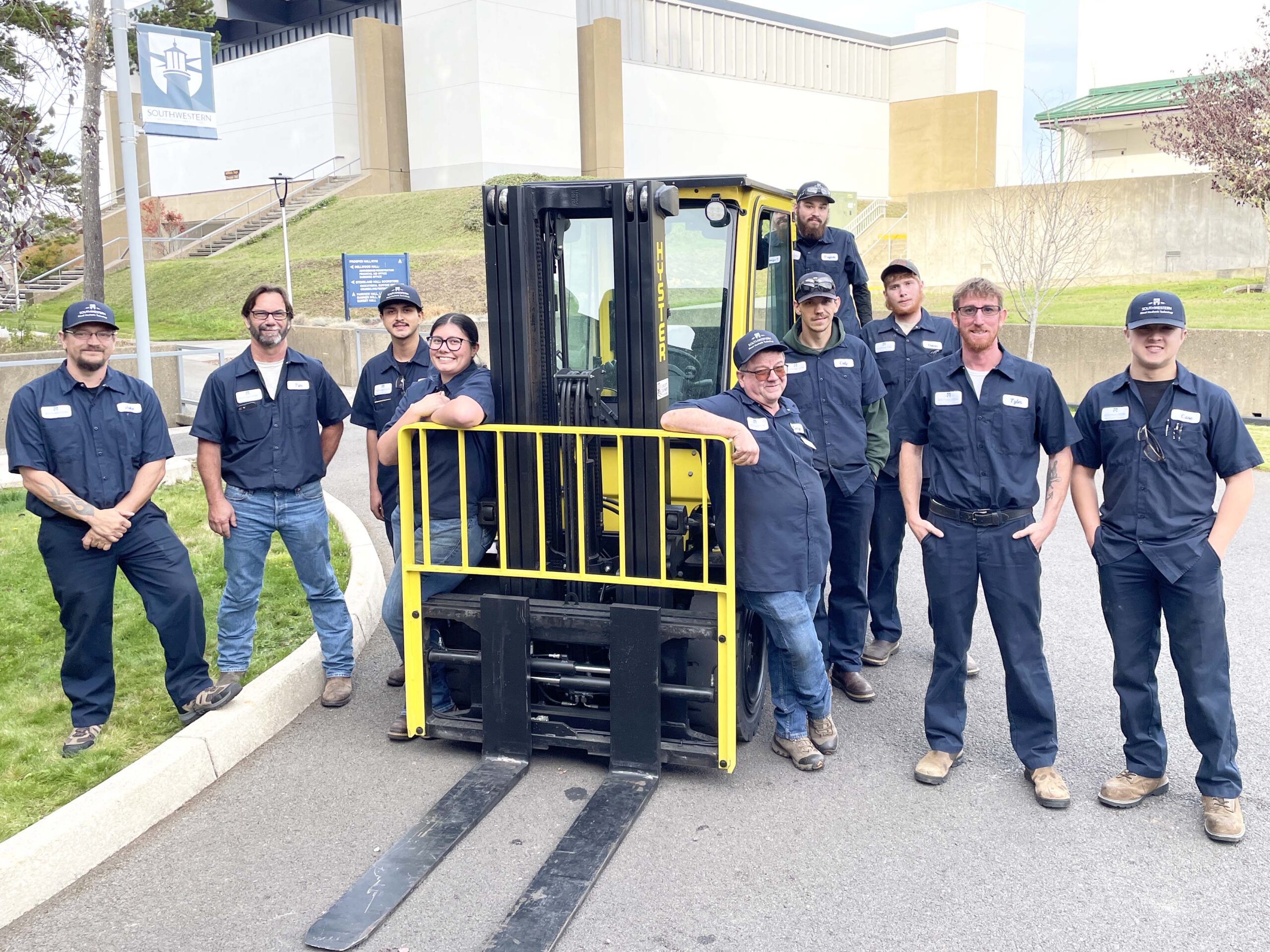 dieselclass Image of the 2025-26 diesel mechanic students and instructors standing around a forklift.
